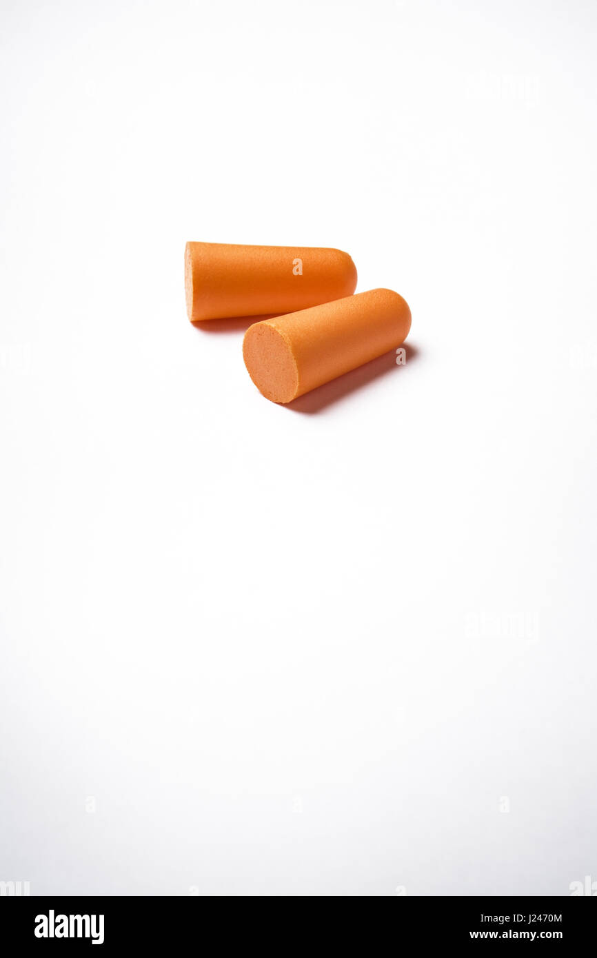 two form ear plugs on a white background to stop you going deaf working in noisy environments. Stock Photo