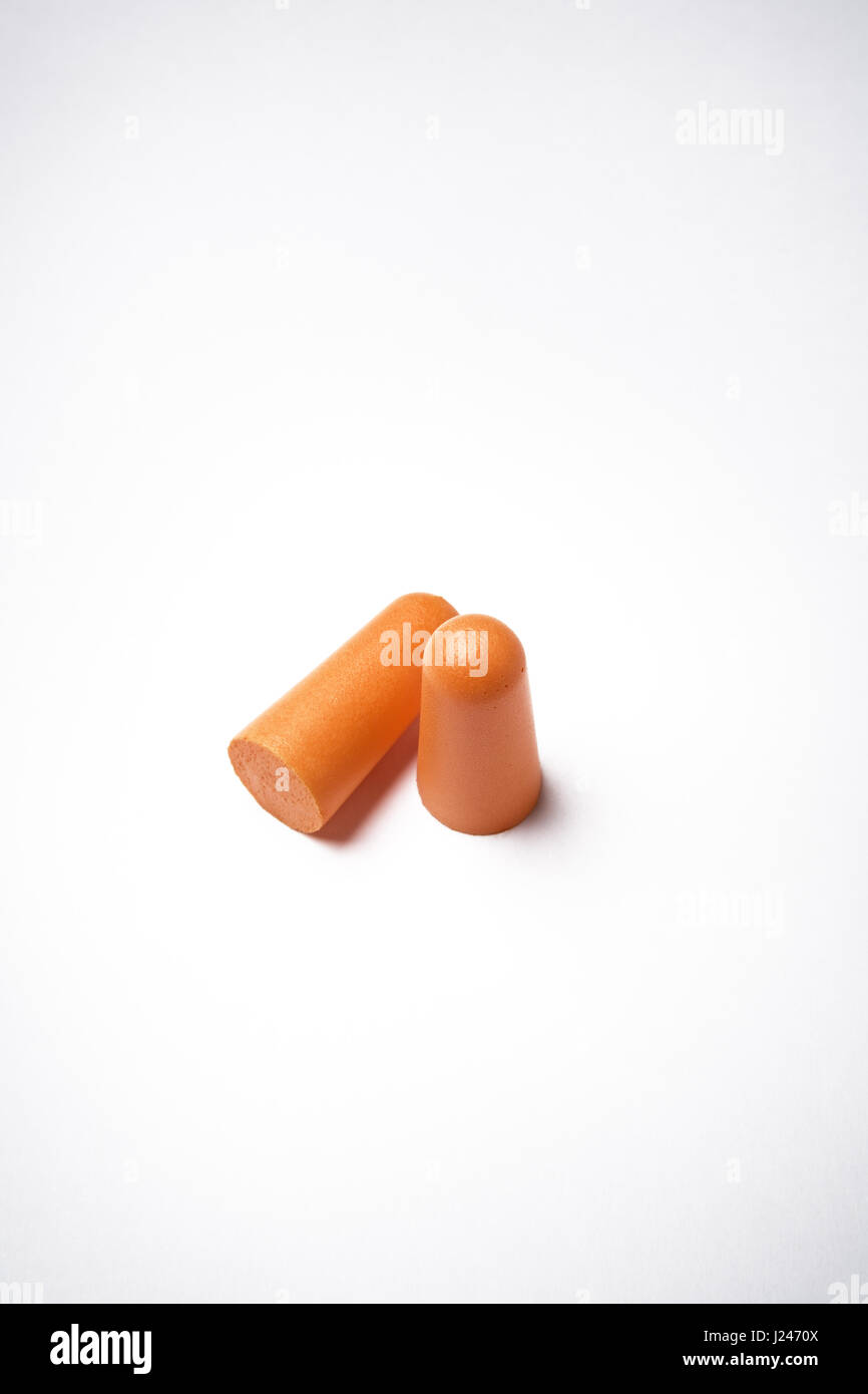 two form ear plugs on a white background to stop you going deaf working in noisy environments. Stock Photo