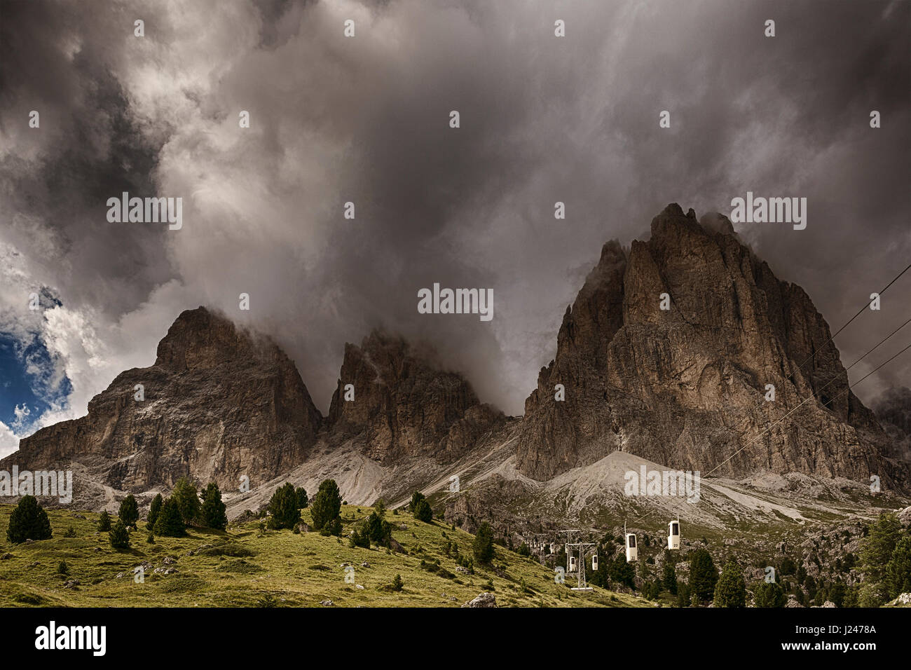 Thunderstorm formation over the top of Sassolungo seen from Sella Pass in a summer afternoon of august Stock Photo