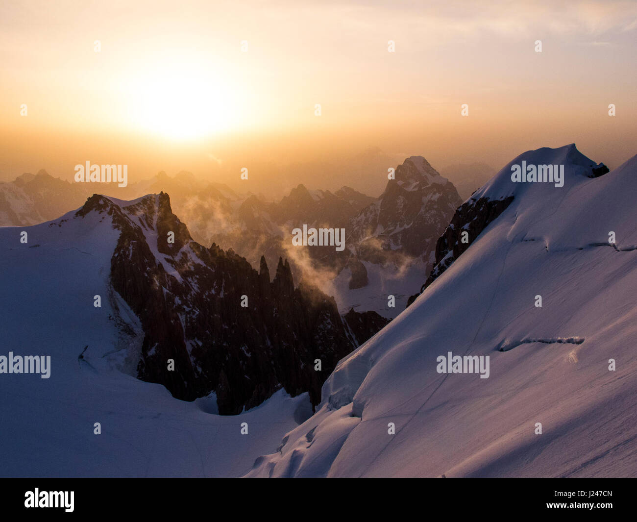 Snowed alpine landscape in the Mont Blanc massif at sunrise Stock Photo ...