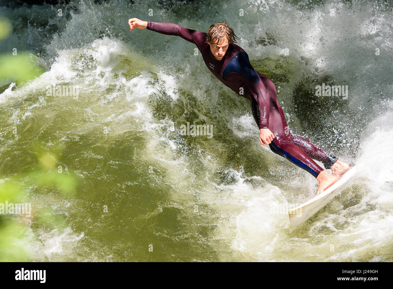 Munich, Germany. 24th Apr, 2017. A man surfs in the English Garden in Munich, Germany, 24 April 2017. Photo: Florian Eckl/dpa/Alamy Live News Stock Photo