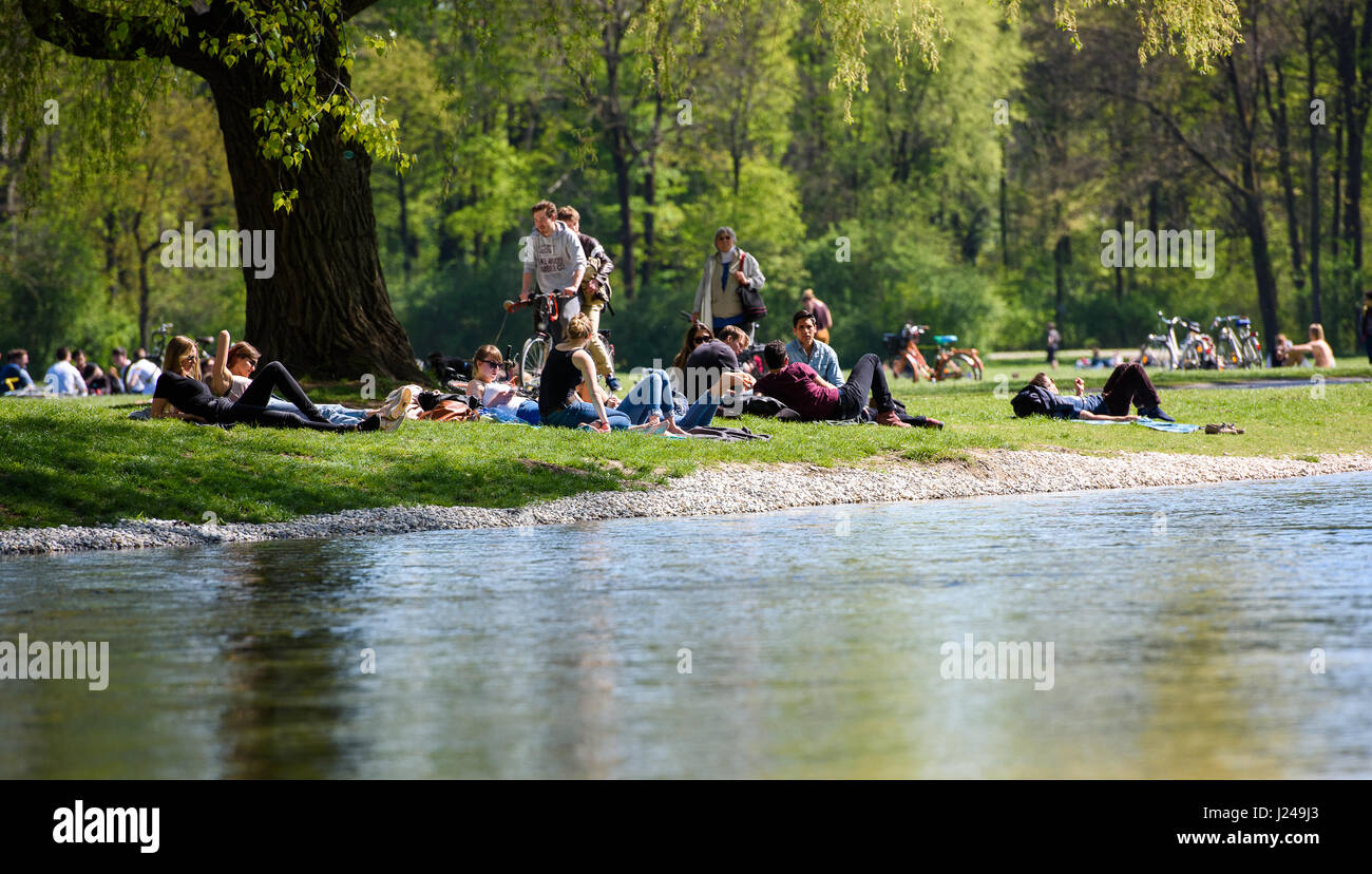 Munich, Germany. 24th Apr, 2017. People sunbathe in the English Garden in Munich, Germany, 24 April 2017. Photo: Florian Eckl/dpa/Alamy Live News Stock Photo