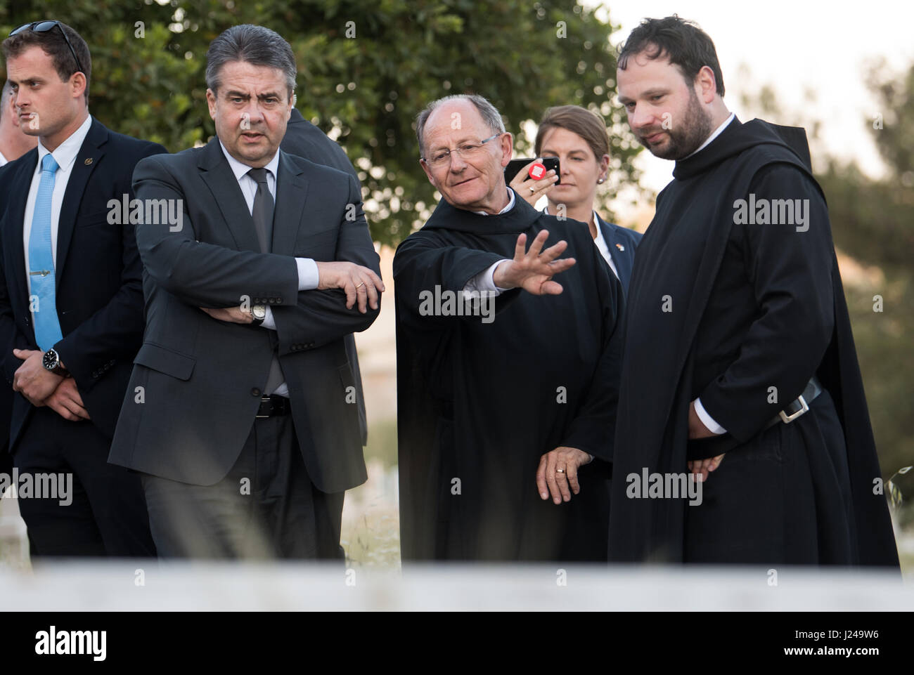 Jerusalem, Israel. 24th Apr, 2017. dpatop - German foreign minister Sigmar Gabriel (SPD) with Nikodemus Schnabel (R), the Abbey of the Dormition's administrator, and Father Elias (C) at the grave of Oskar Schindler (1908-1974) in Jerusalem, Israel, 24 April 2017. Gabriel is currently conducting a short visit to the Middle East. He will visit Israel, Jordan and the autonomous Palestinian territories today and tomorrow. Photo: Bernd von Jutrczenka/dpa/Alamy Live News Stock Photo