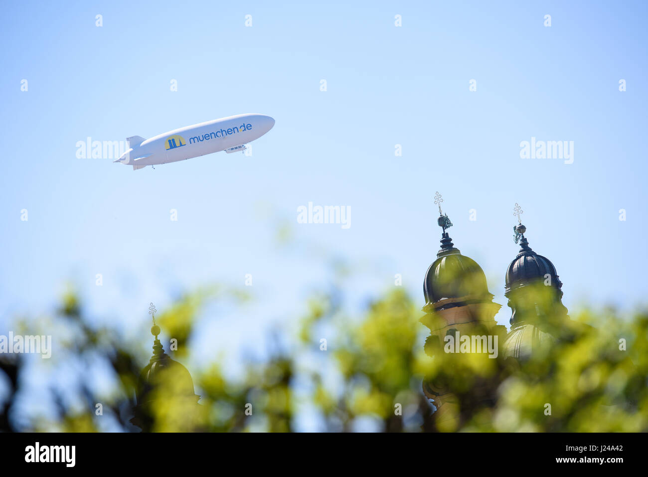 Munich, Germany. 24th Apr, 2017. dpatop - A zeppelin flies over the city centre of Munich, Germany, 24 April 2017. Photo: Florian Eckl/dpa/Alamy Live News Stock Photo