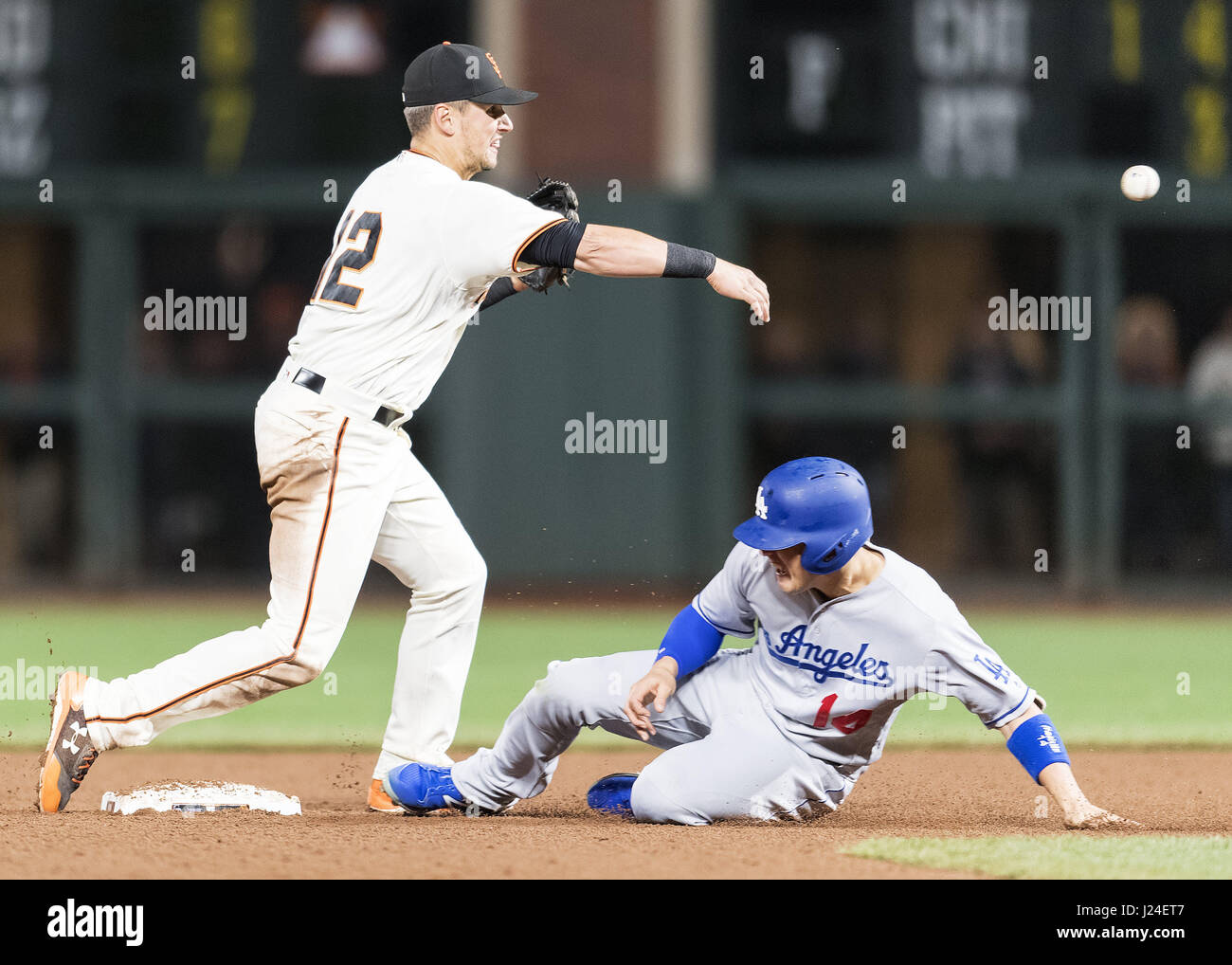 San Francisco, California, USA. 24th Apr, 2017. San Francisco Giants second baseman Joe Panik (12) tags the base to get Los Angeles Dodgers shortstop Enrique Hernandez (14) out at second base and make the throw for a double play during a MLB baseball game between the Los Angeles Dodgers and the San Francisco Giants at AT&T Park in San Francisco, California. Valerie Shoaps/CSM/Alamy Live News Stock Photo