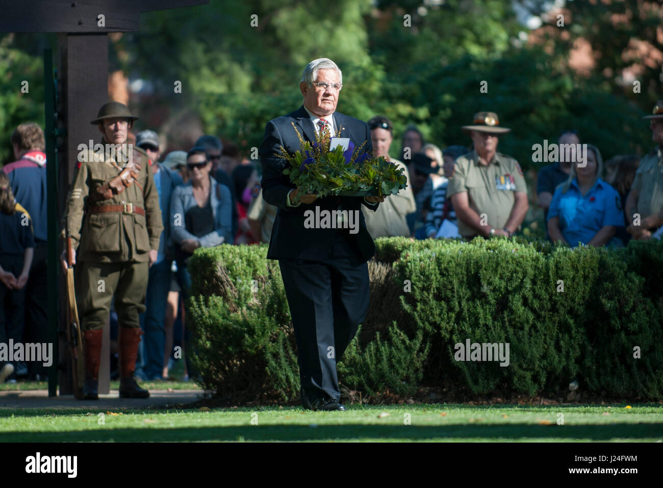 Guildford, Perth, Western Australia, Australia. 25th April, 2017. Australian Federal politician Ken Wyatt AM, MP, carrying a floral wreath at ANZAC Day service in Guildford, Western Australia.    Sheldon Levis/Alamy Live News Stock Photo