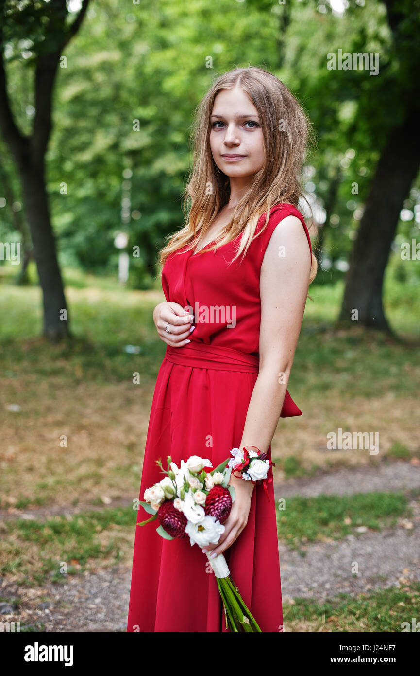 Cute girl bridesmaid at red dress with wedding bouquet at hand Stock ...