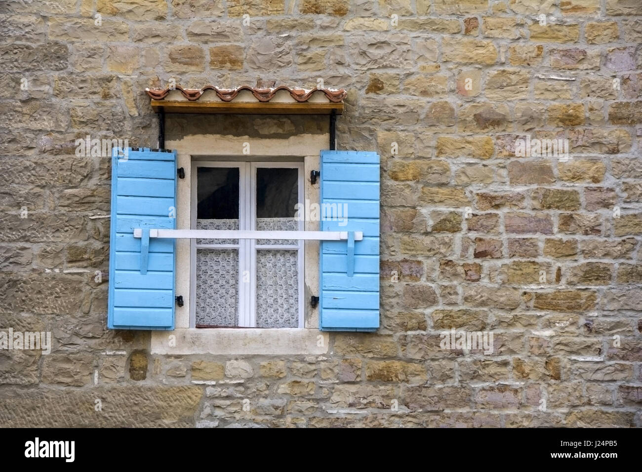Blue wooden window shutters on the old stone house Stock Photo - Alamy