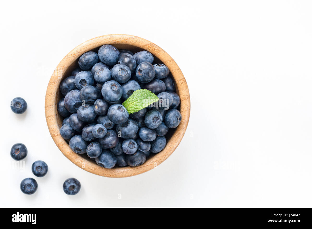 Bowl of fresh blueberries isolated on white, top view copy space Stock Photo