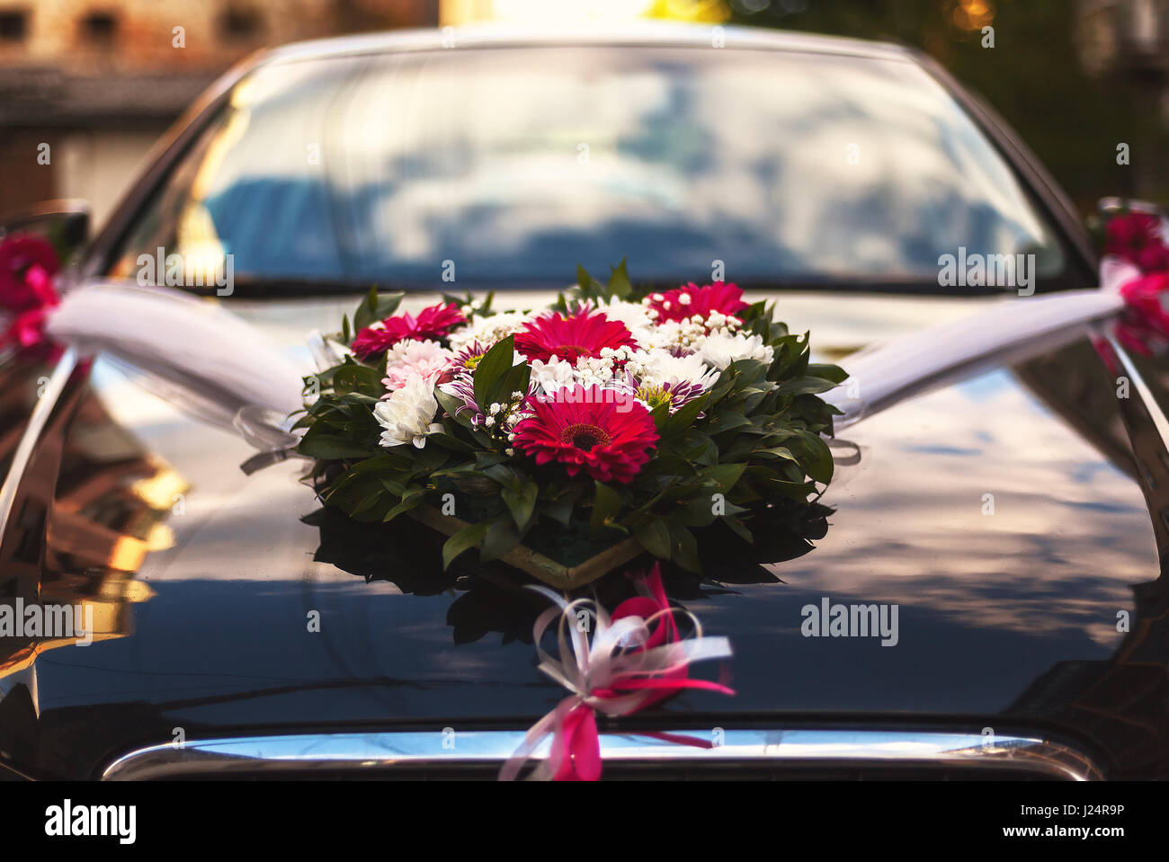 Closeup view on flower decoration on modern wedding car Stock
