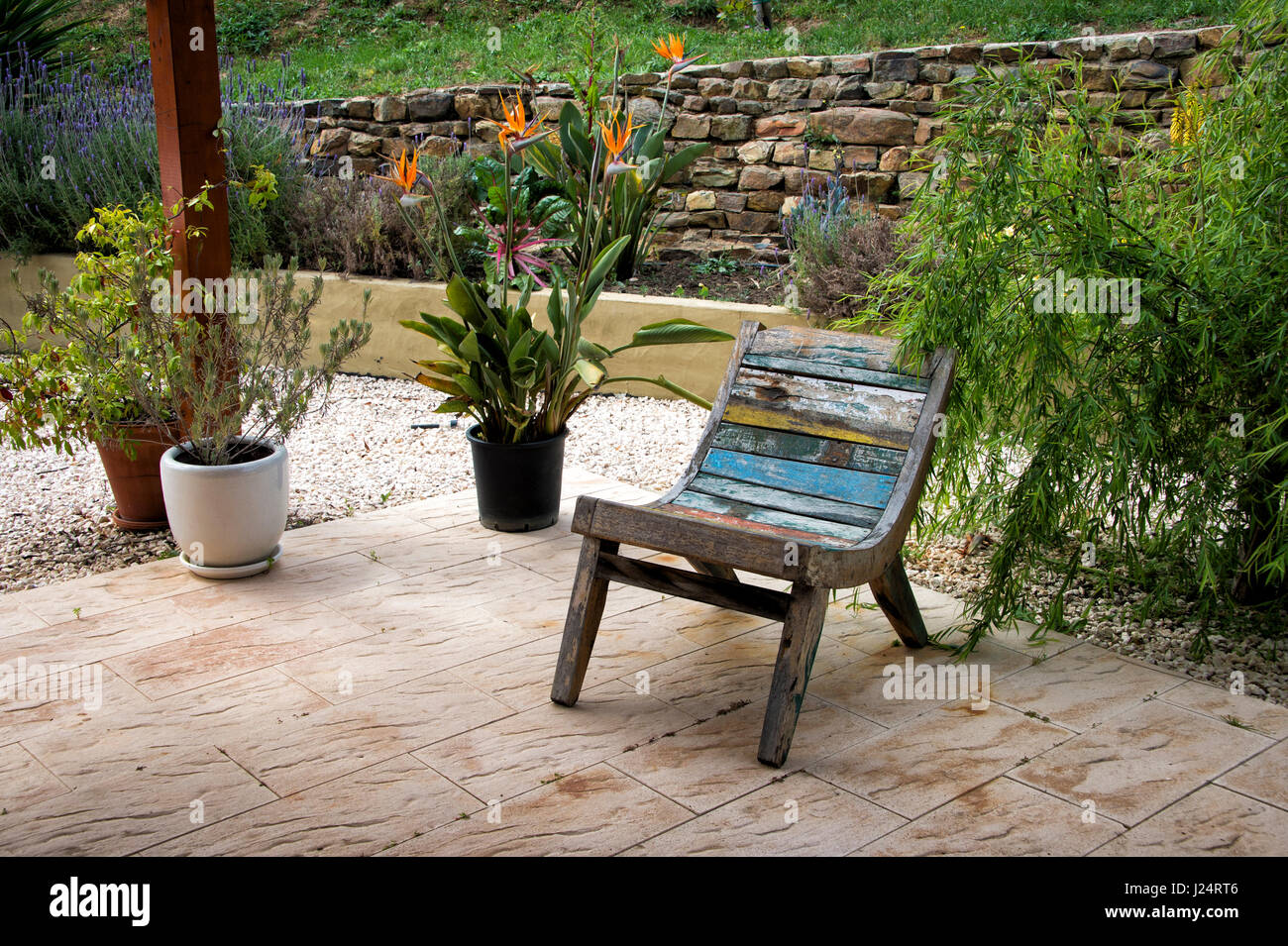 wooden garden chair on a patio Stock Photo - Alamy