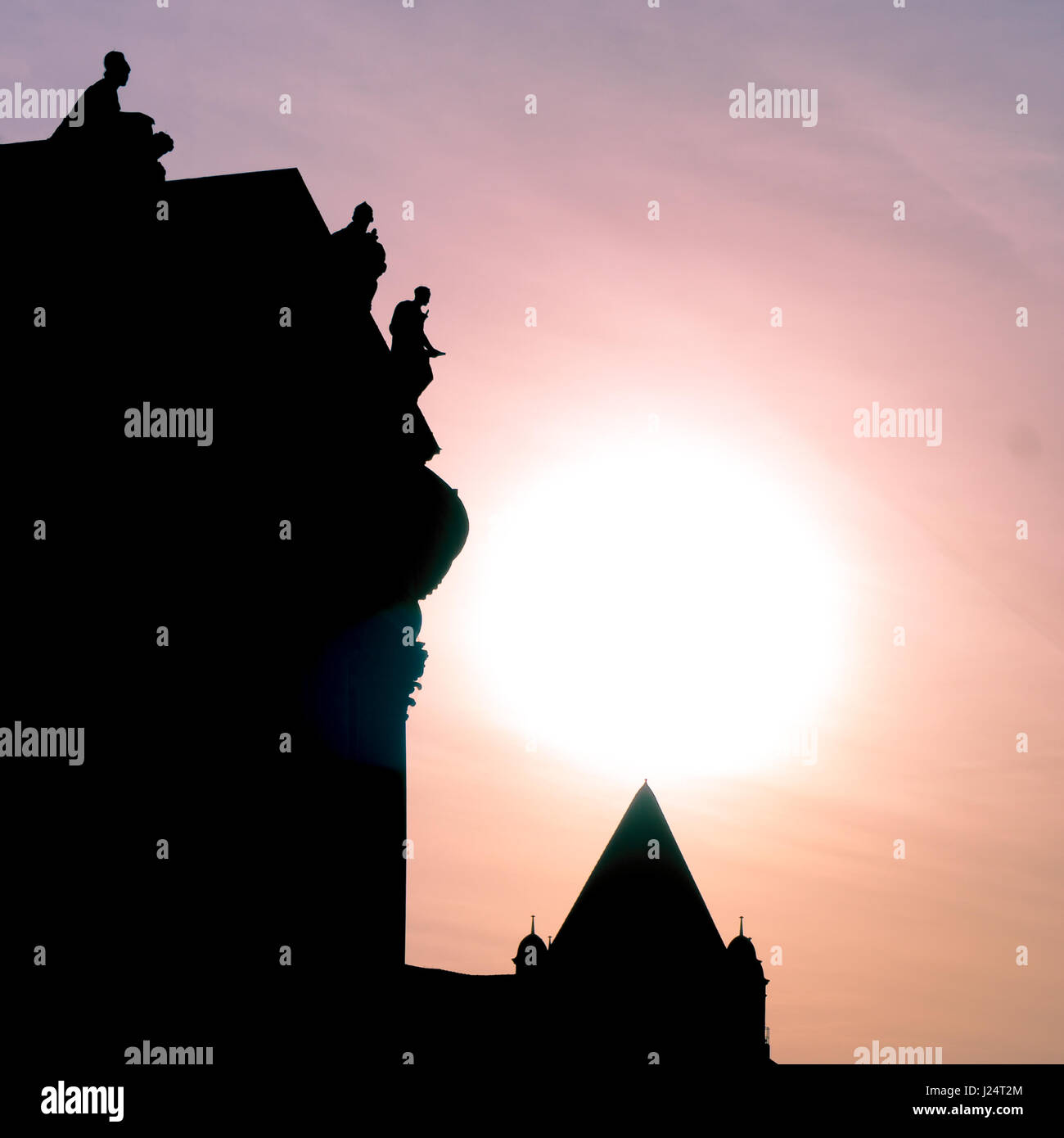 Silhouettes of old statues on the roof of the Bodemuseum in Berlin. This picture was taken at sunset. Stock Photo