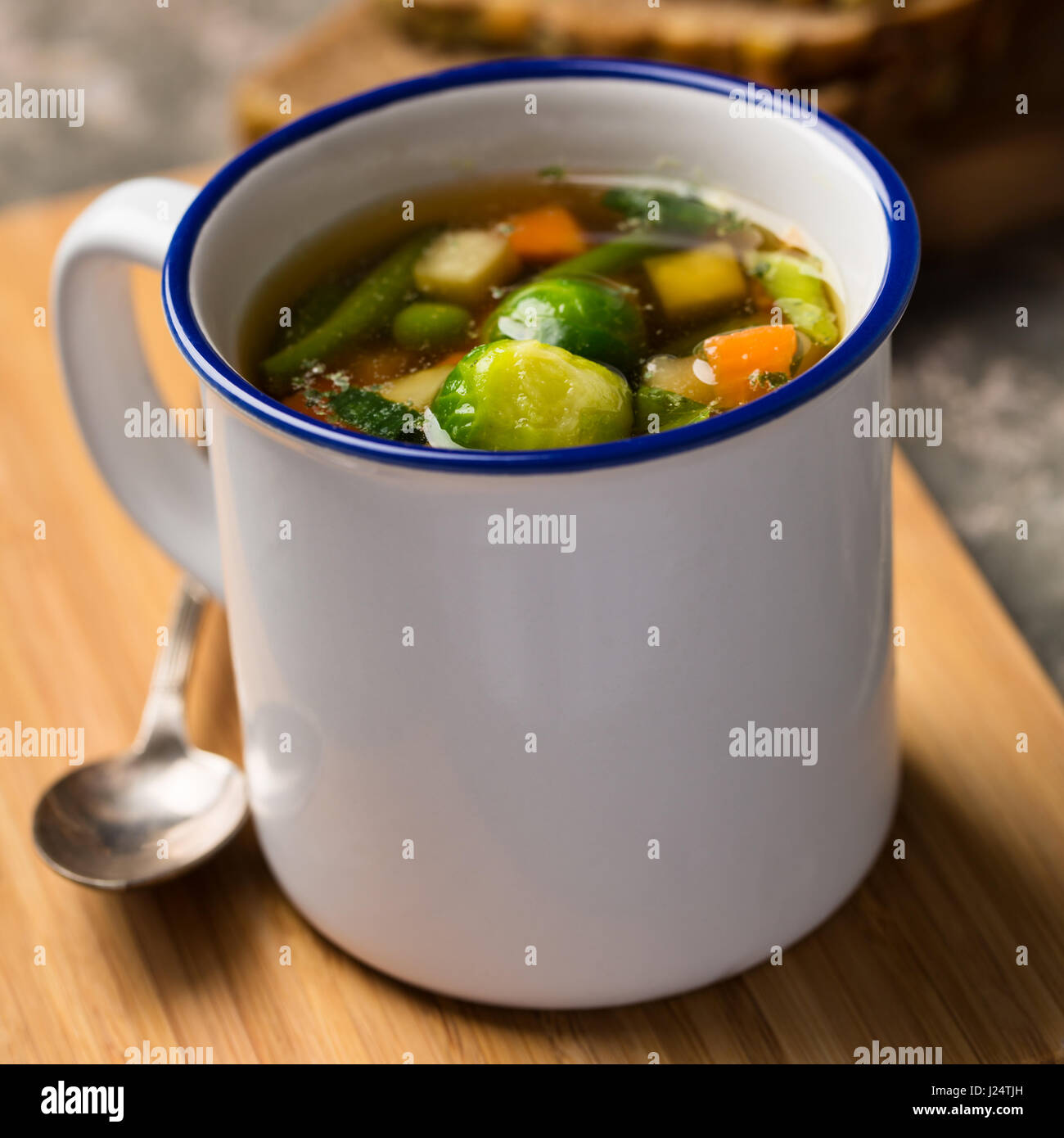 Vegan vegetable soup with brussels sprouts, carrots, peas and beans. Stock Photo