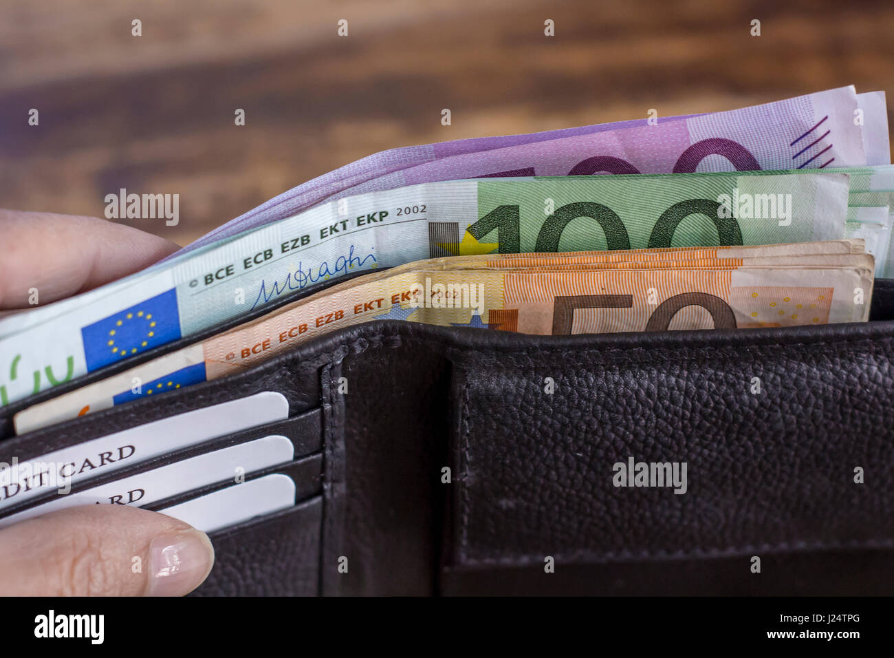 Euro money notes in the wallet on rustic wooden Background Stock Photo ...