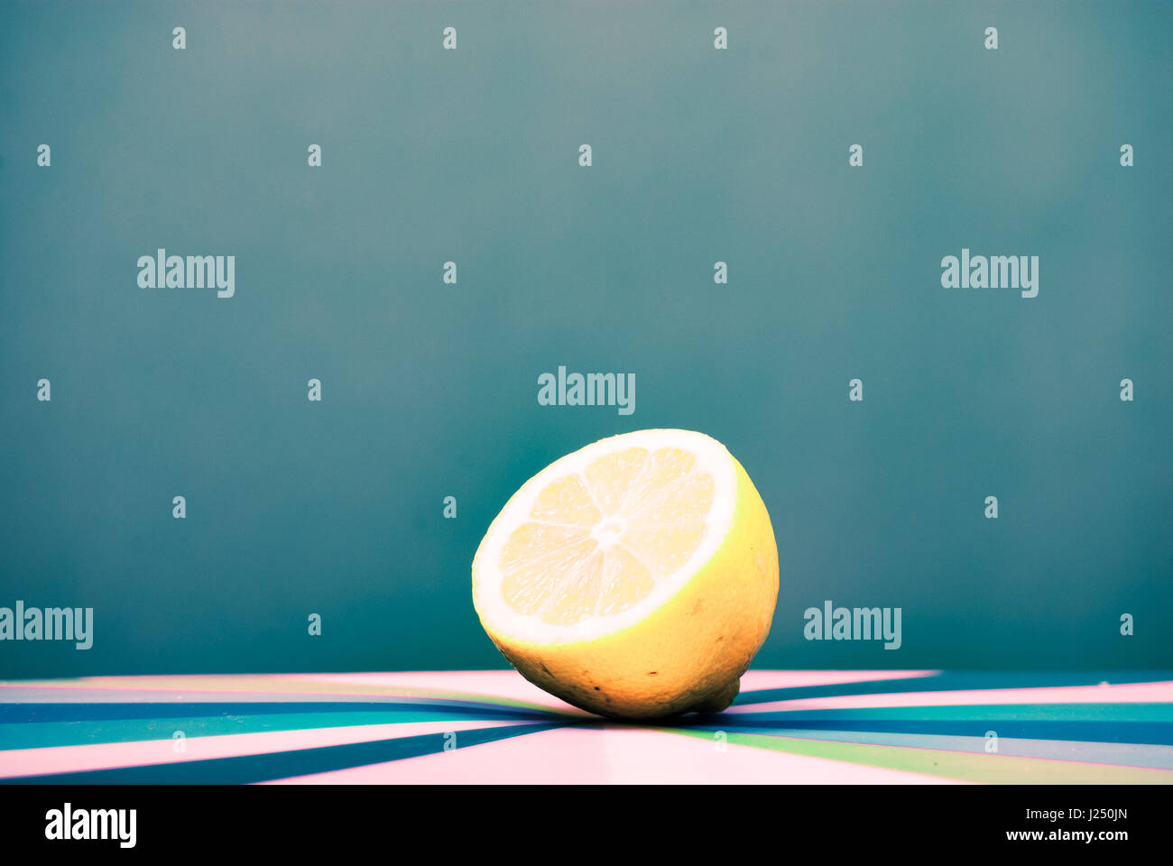 cut lemon on colorful background Stock Photo - Alamy