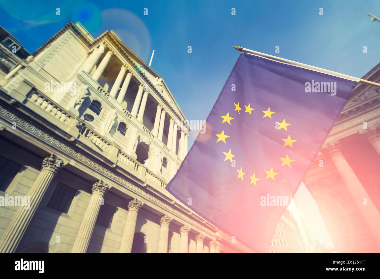 EU European Union flag flying in front of the traditional buildings in the financial capital of the City of London, UK Stock Photo