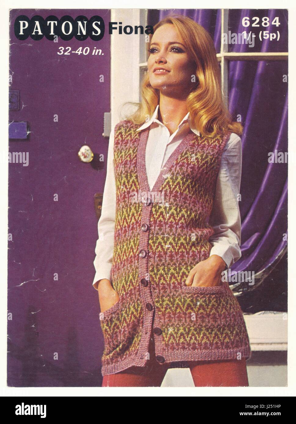 Original example of Patons retro knitting pattern from the late 1970's, the model is wearing a long hand knitted Fairisle style button down cardigan, U.K. circa 1979 Stock Photo