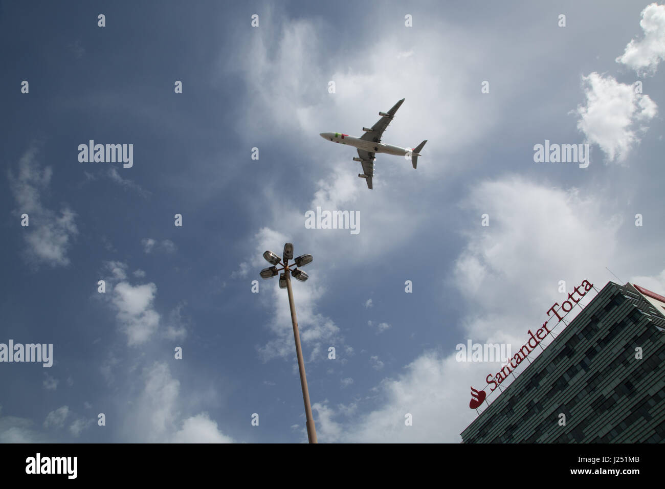 An aeroplane flying low over a hotel in Lisbon. Portugal. Stock Photo