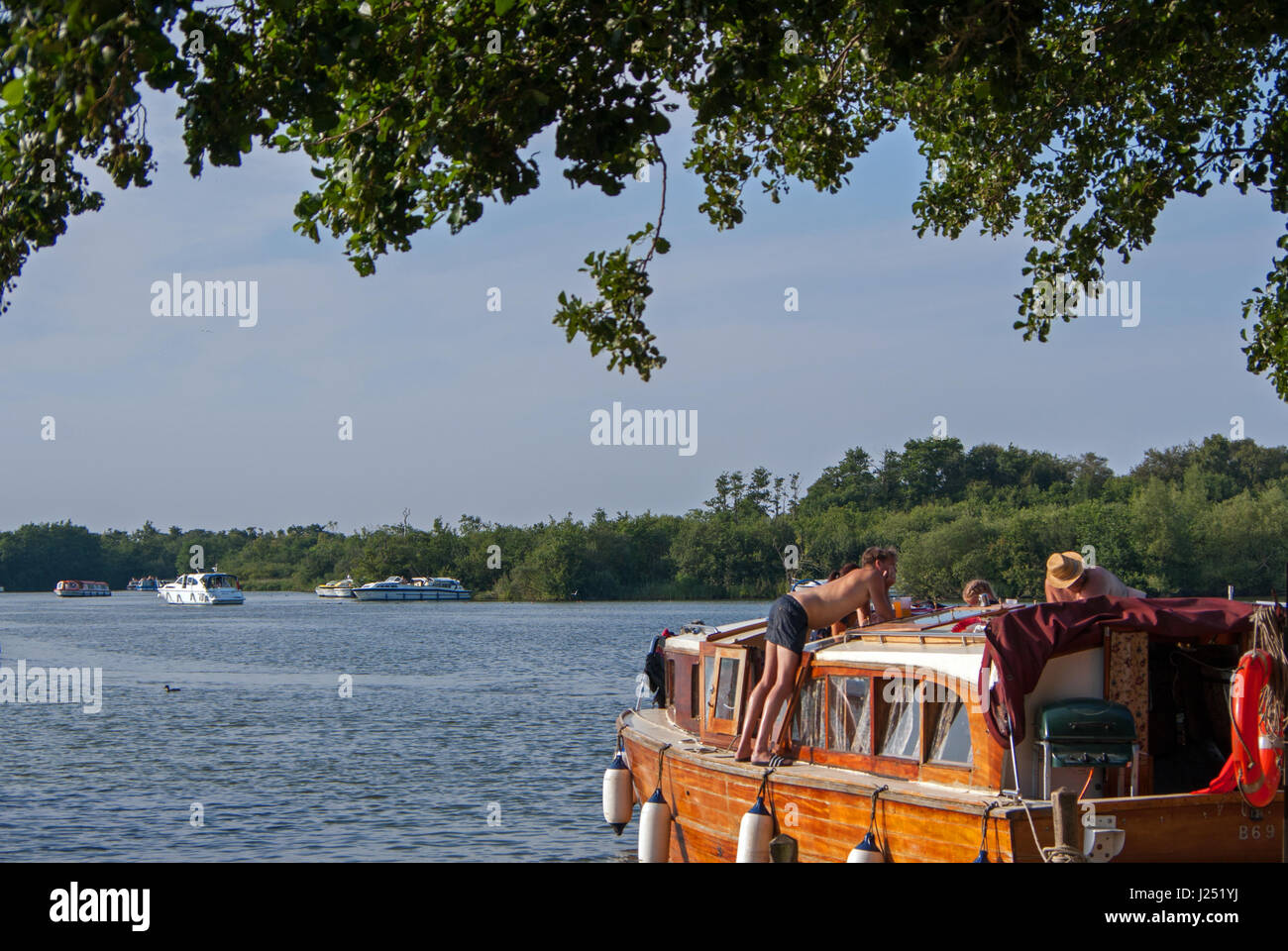 Relaxing Family Boating Holidays on The Norfolk Broads at Picturesque Malthouse Broad, Ranworth, Norfolk, England, UK Stock Photo