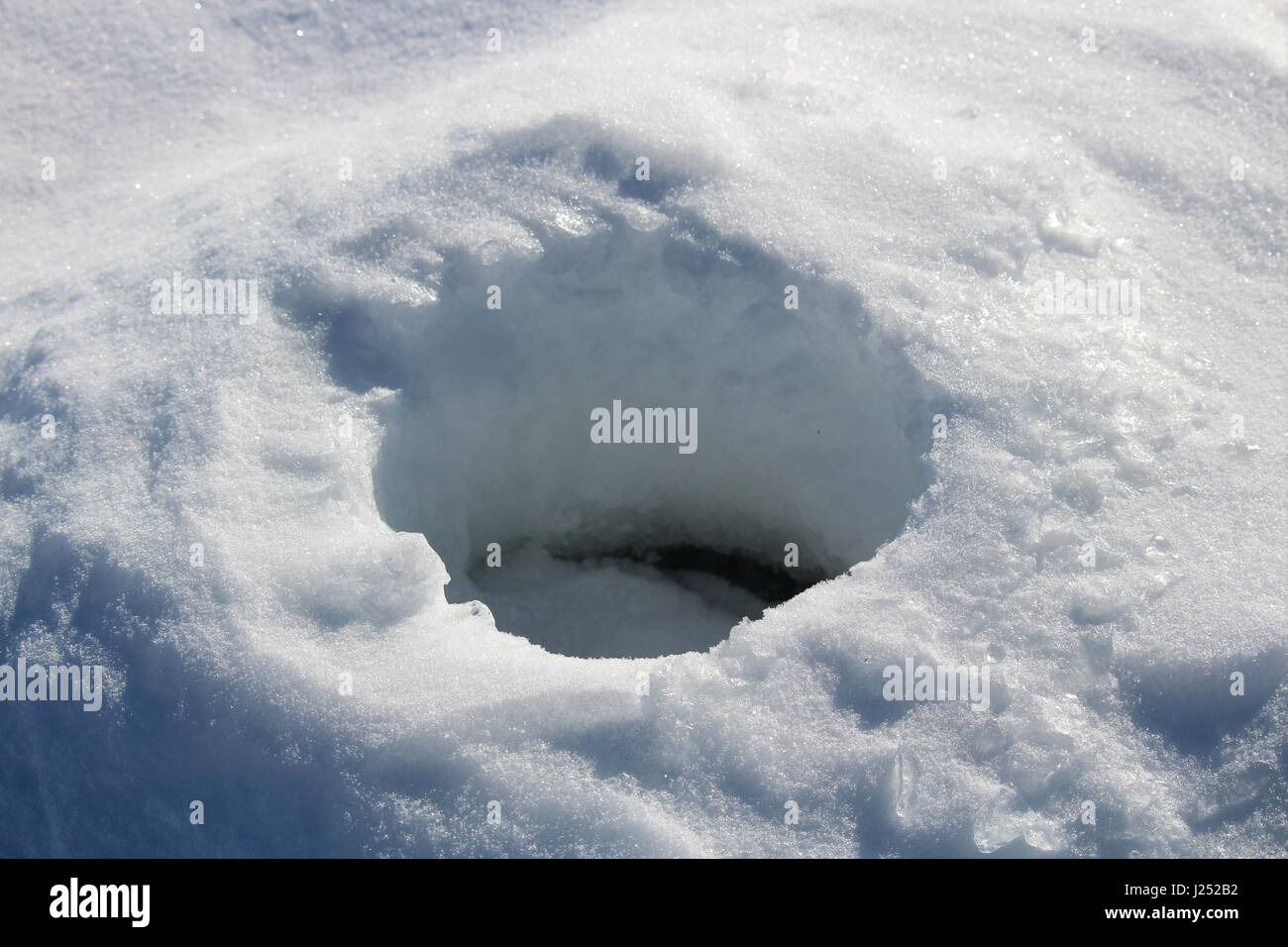 Old Frozen Ice Fishing Hole. Stock Photo