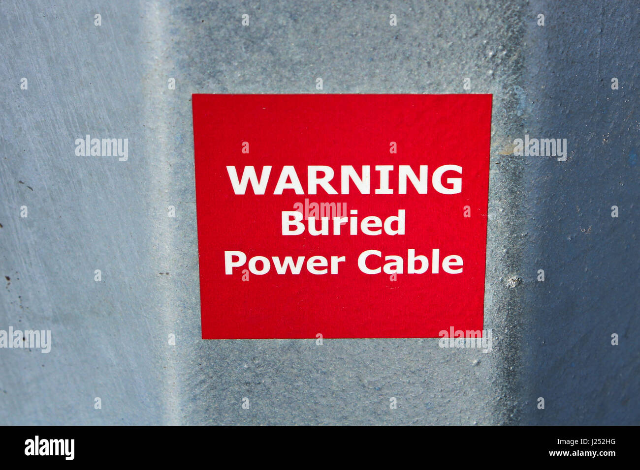 Warning Buried Power Cable Sign on Metal Pole. Stock Photo