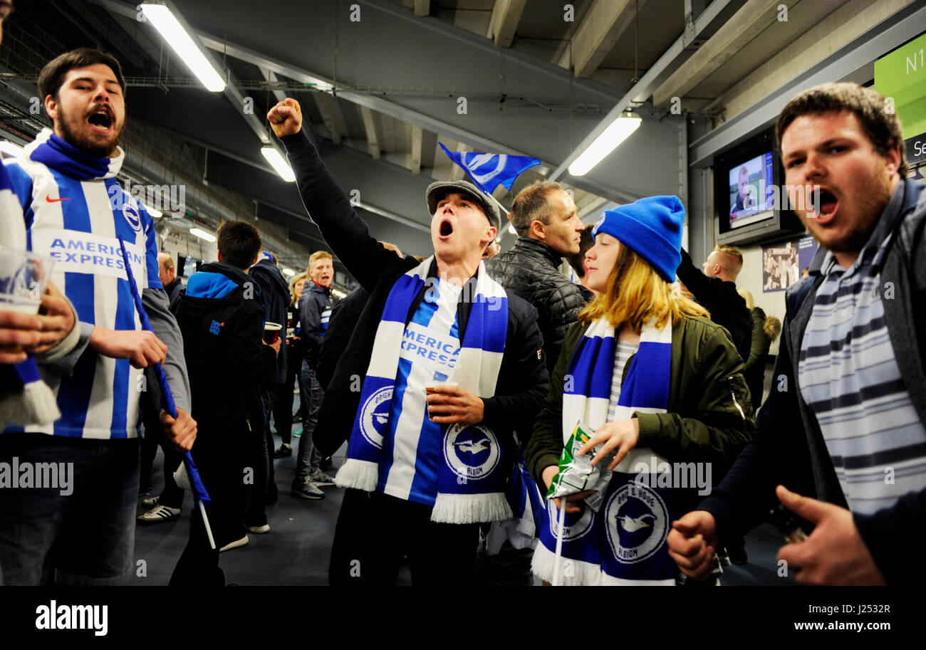Brighton fans celebrate promotion in stadium bars as Hudderfield can only manage a draw against Derby after the Sky Bet Championship match between Brighton and Hove Albion and Wigan Athletic at the American Express Community Stadium in Brighton and Hove. April 17, 2017. Simon  Dack / Telephoto Images FA Premier League and Football League images are subject to DataCo Licence see www.football-dataco.com Editorial use only Stock Photo