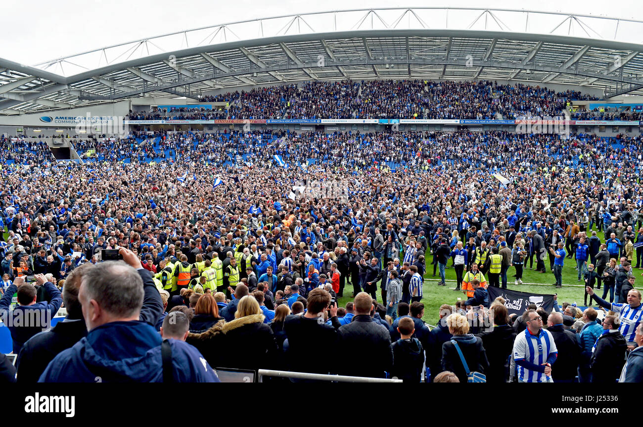 Brighton and Hove Albion football fans celebrating being promoted to the Premier League after beating Wigan in the Sky Bet Championship match at the American Express Community Stadium FA Premier League and Football League images are subject to DataCo Licence see www.football-dataco.com Editorial use only Stock Photo