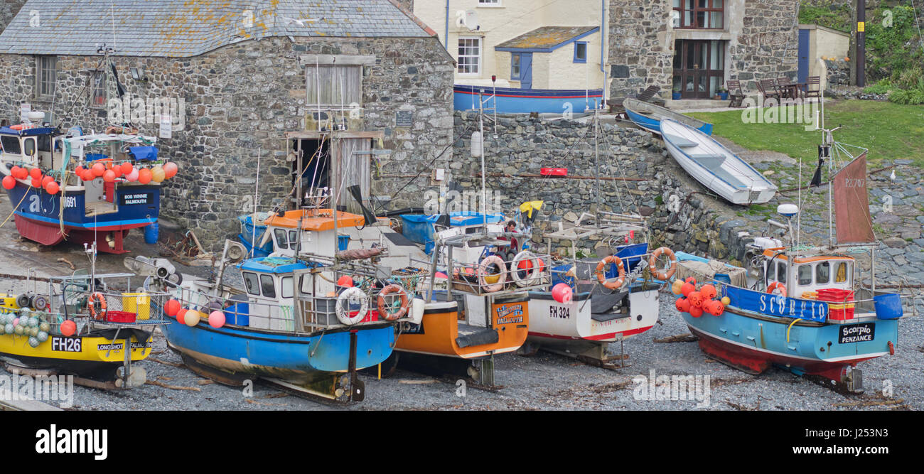 Fishing boats beached in a Cornish harbour. Their crustacean and white fish catches are a vital part of the local economy Stock Photo