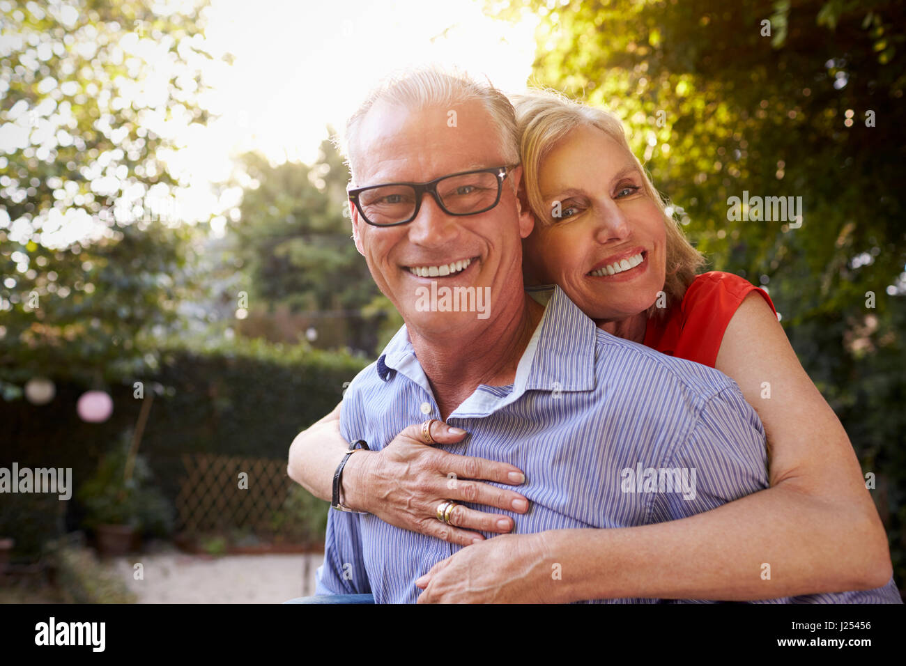 Portrait Of Loving Mature Couple In Back Yard Garden Stock Photo - Alamy