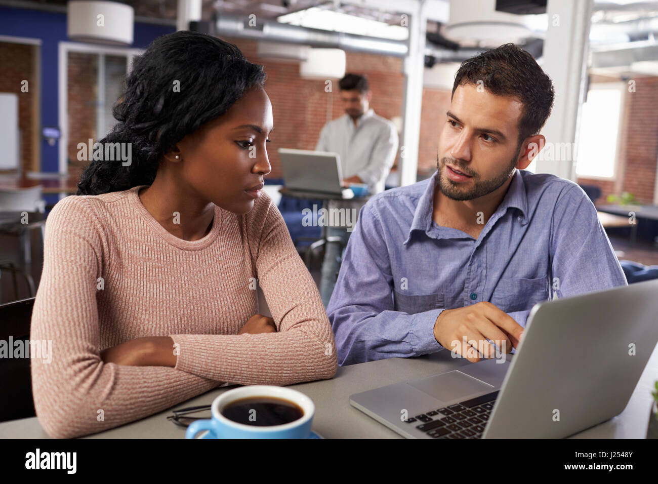 Businessman And Businesswoman At Informal Meeting In Office Stock Photo ...
