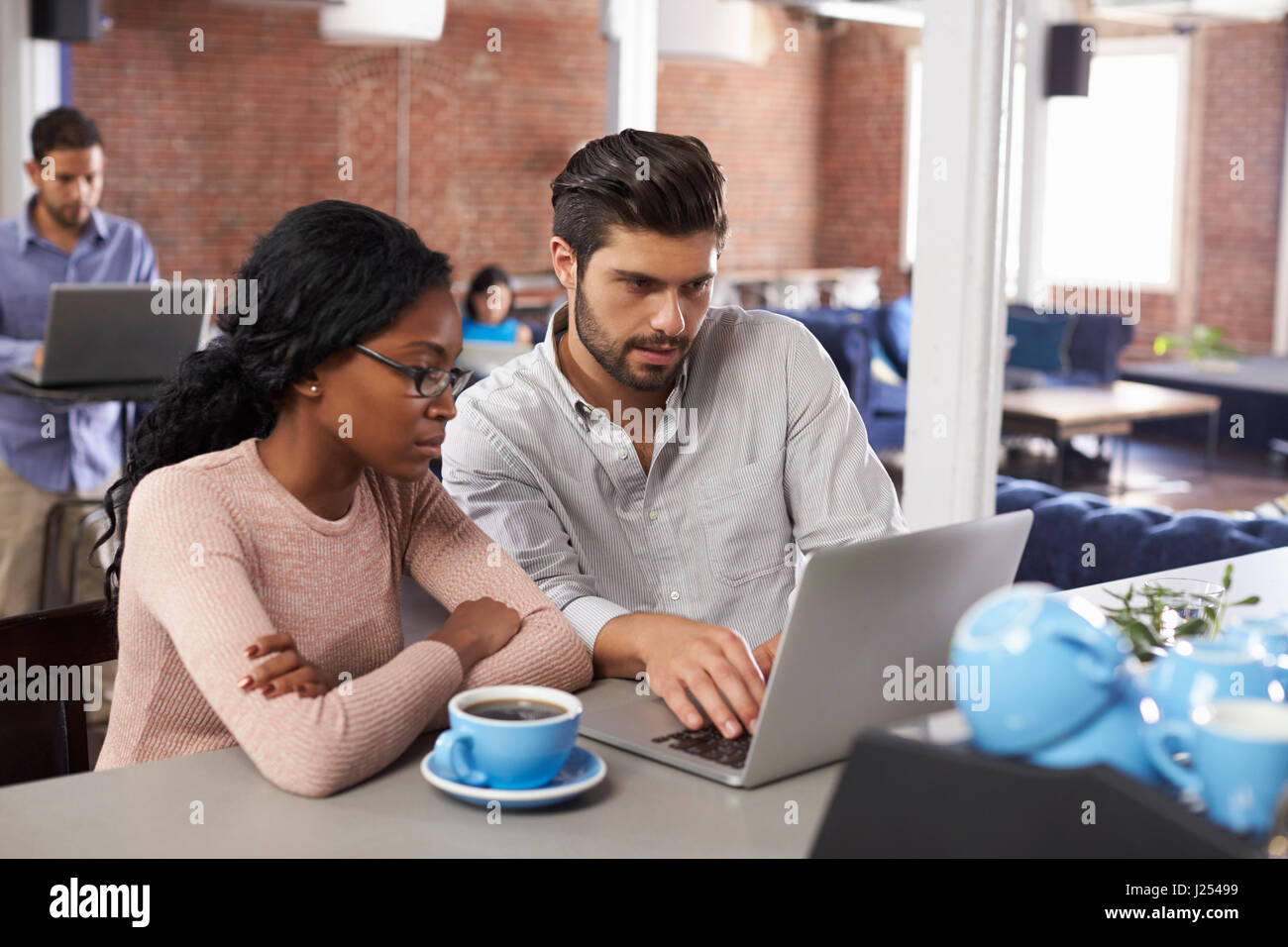 Businessman And Businesswoman At Informal Meeting In Office Stock Photo ...