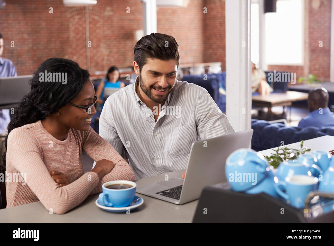 Businessman And Businesswoman At Informal Meeting In Office Stock Photo ...
