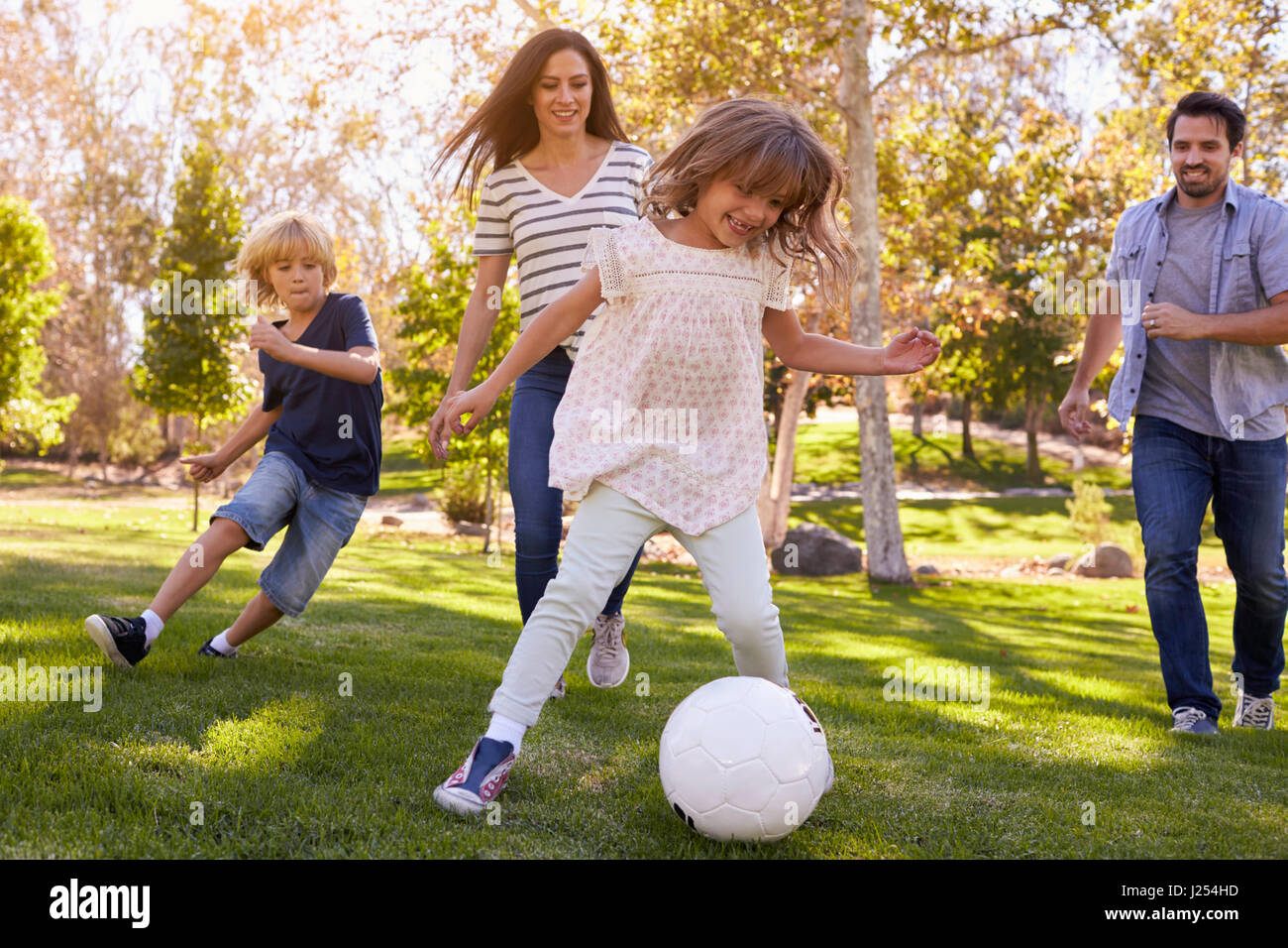 Family Playing Soccer In Park Together Stock Photo - Alamy