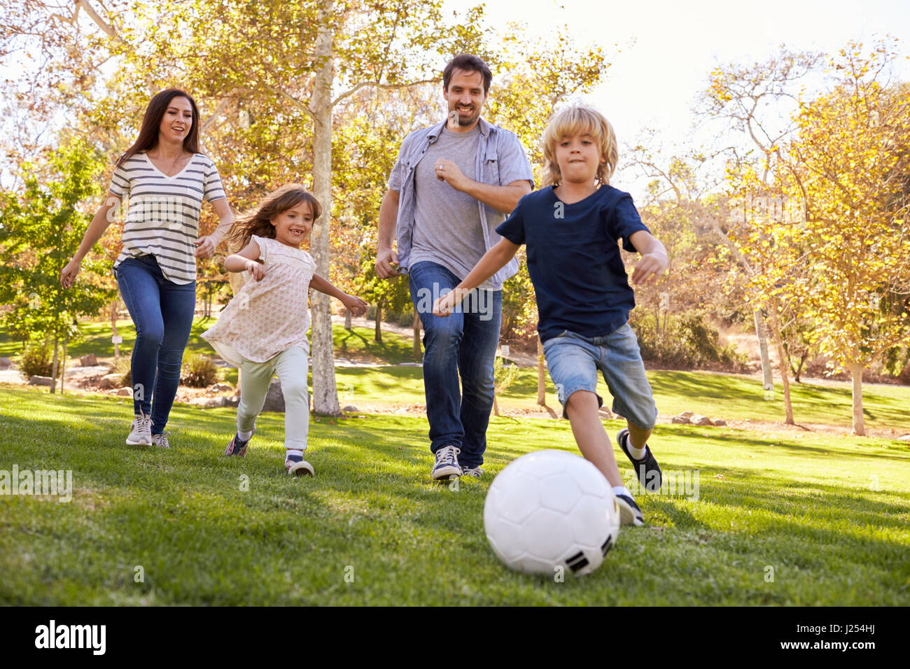 Family Playing Soccer In Park Together Stock Photo - Alamy