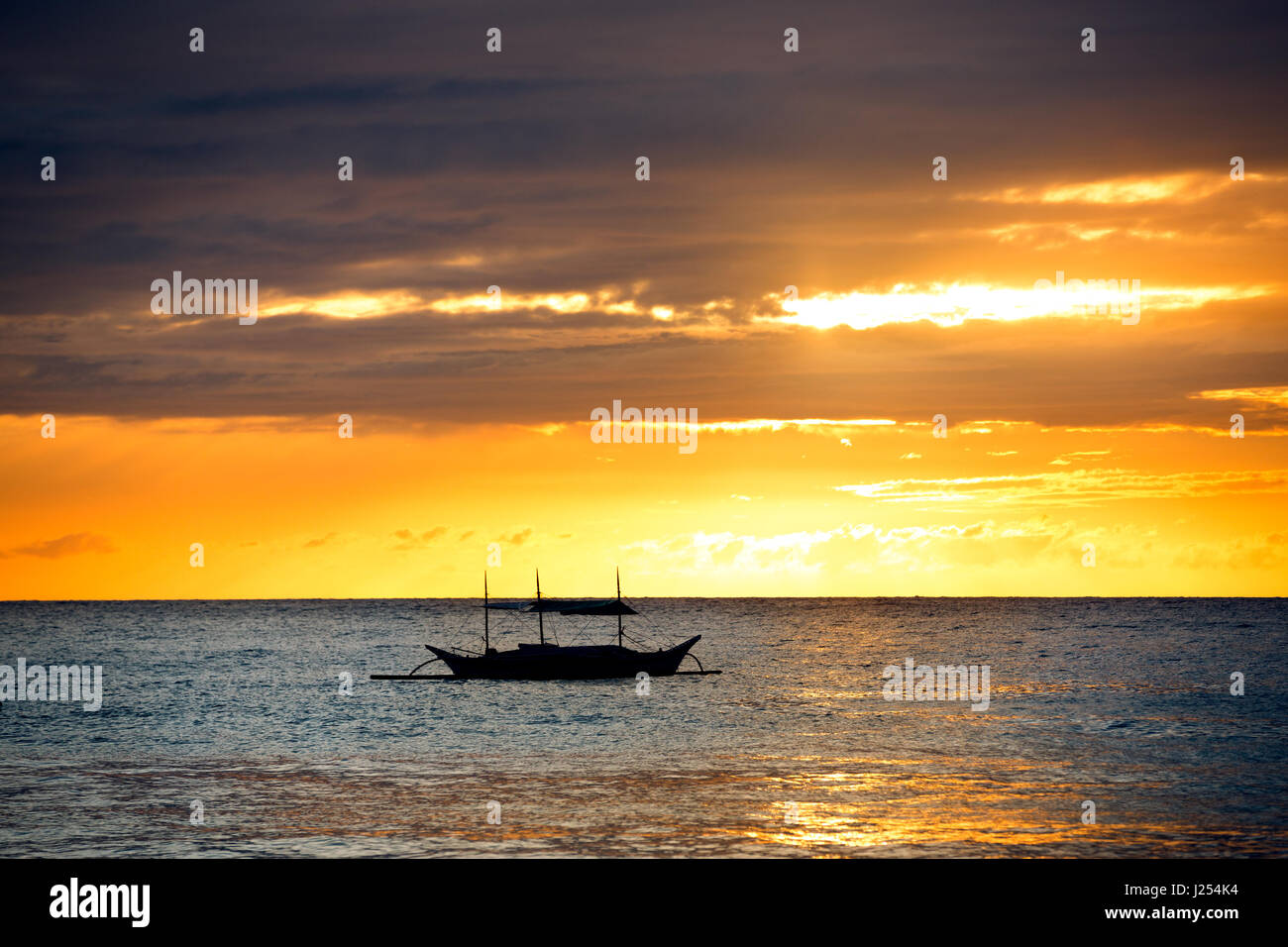 boat in the sea sunset background Stock Photo - Alamy