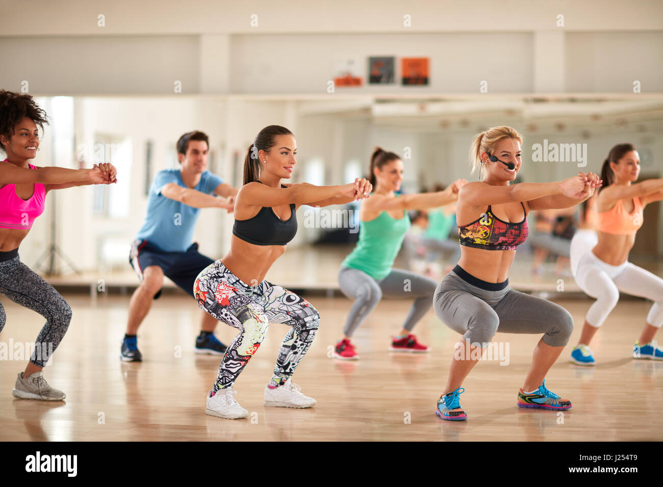Fitness group doing exercises for shaping breech on fitness class Stock Photo