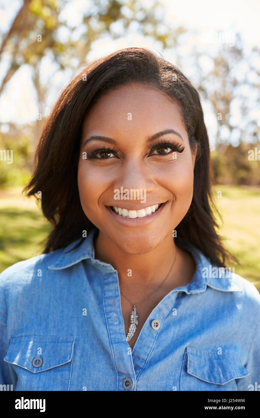 Head And Shoulders Portrait Of Young Woman In Park Stock Photo - Alamy