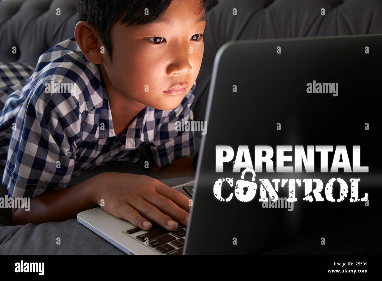 Boy Using Laptop with Parental Control Message Stock Photo