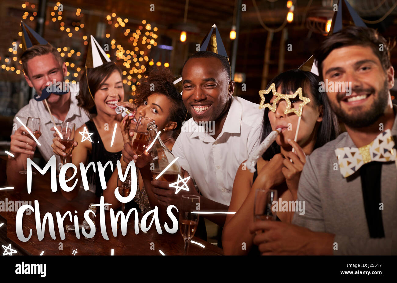 Friends at a party in a bar with Merry Christmas message Stock Photo