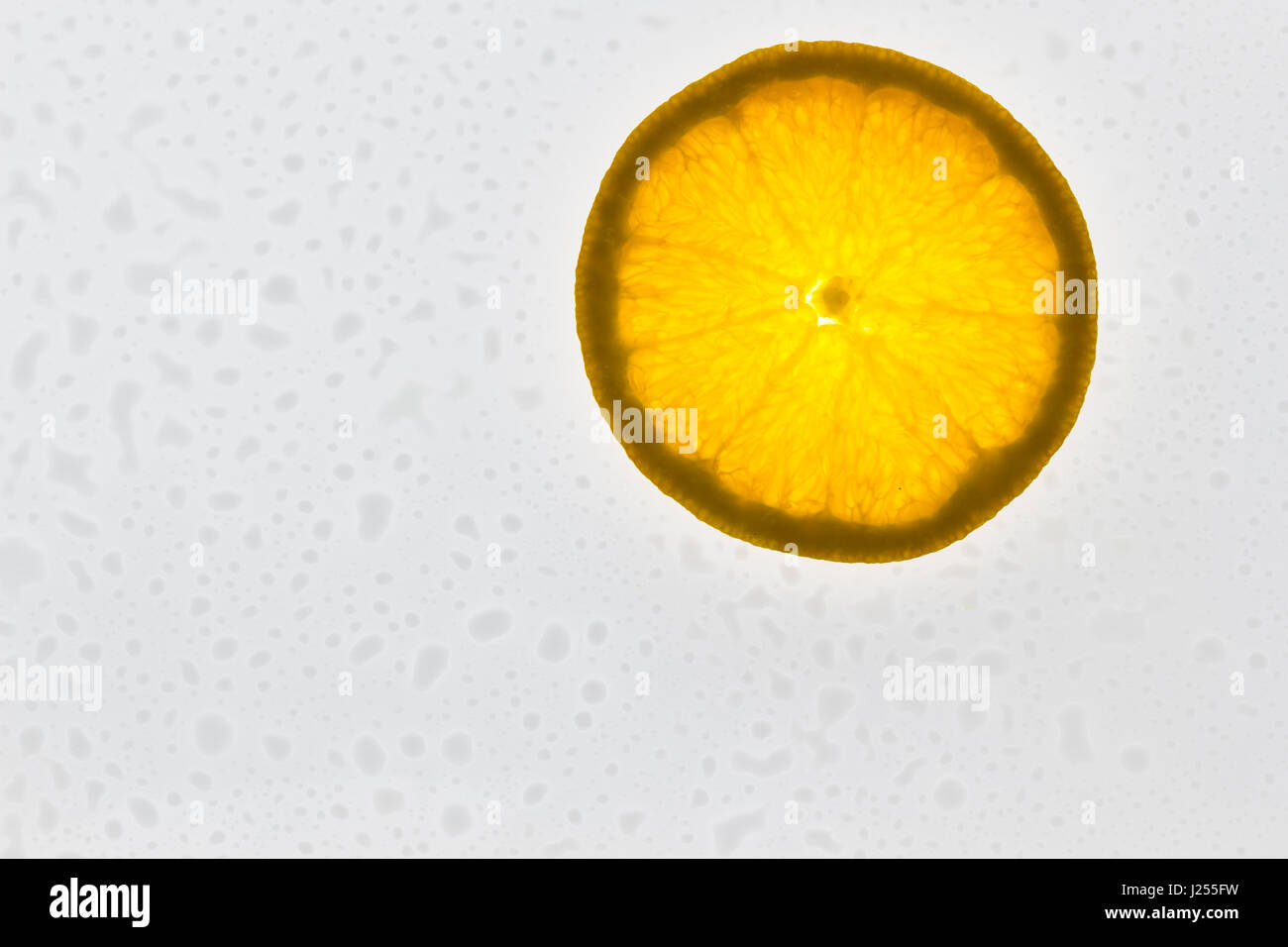Slice of orange fruit on white background with water drops. close-up ...