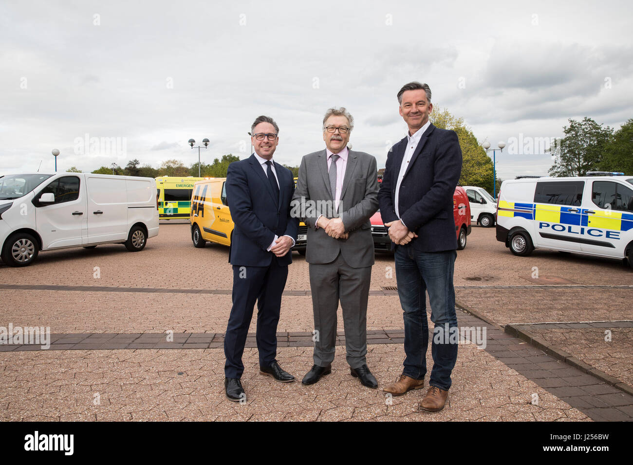 (Left to right) Richard Burnett (Road Haulage Association Chief Executive), Ian Chisholm (SOE, Society of Operations Engineers) and Mike Hawes (CEO of Society of Motor Manufacturers and Traders) pose in front of seven Euro VI emergency response, service and delivery vehicles on display at the 2017 Commercial Vehicle Show at the Birmingham NEC. Stock Photo