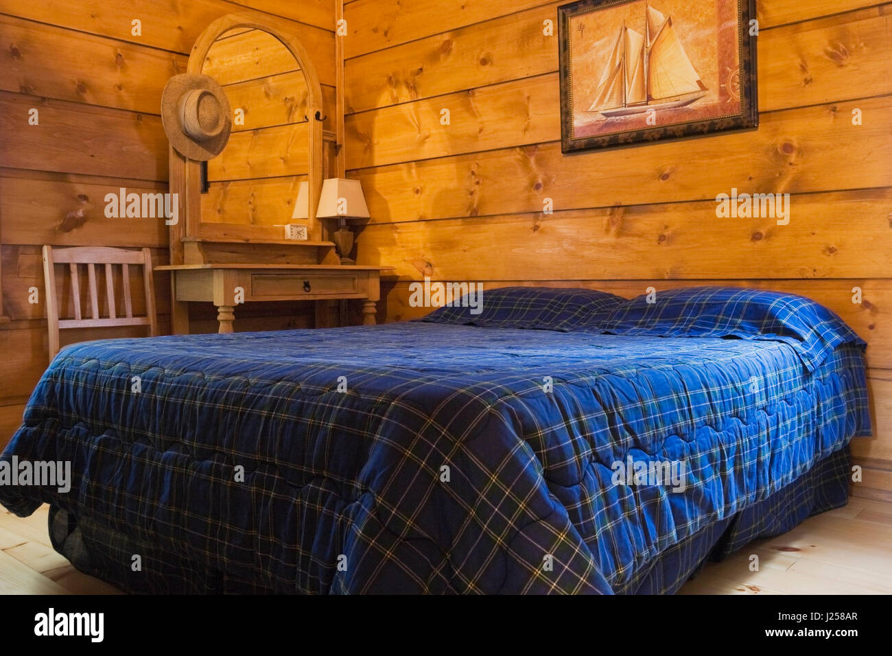 Guest Bedroom Inside A Canadiana Cottage Style Log Home Stock