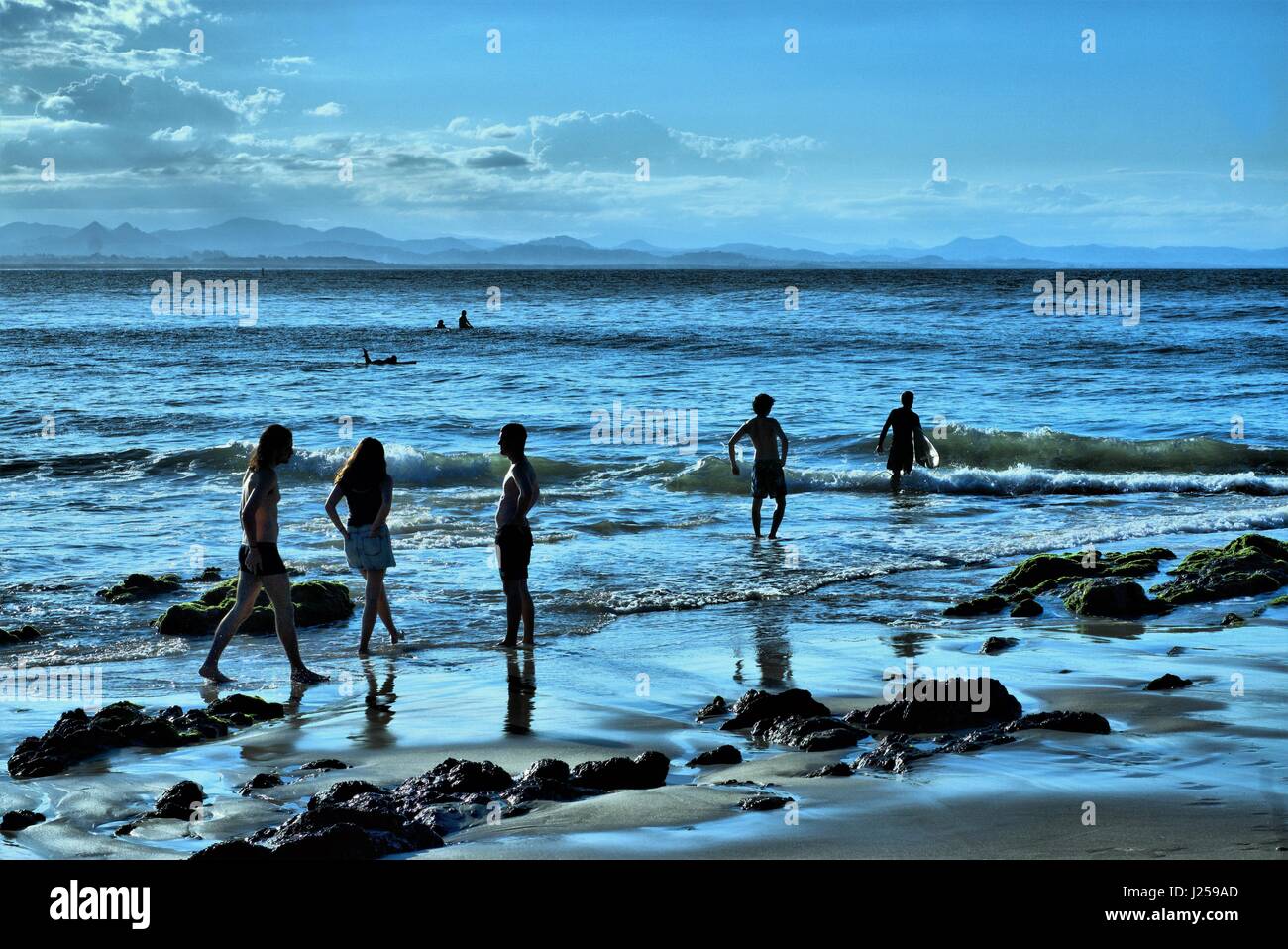People on beach. Silhouettes of people Byron Beach in New South Wales in Australia. Stock Photo