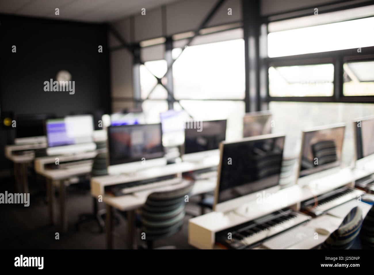 Blur image of chairs and computers in recording studio Stock Photo