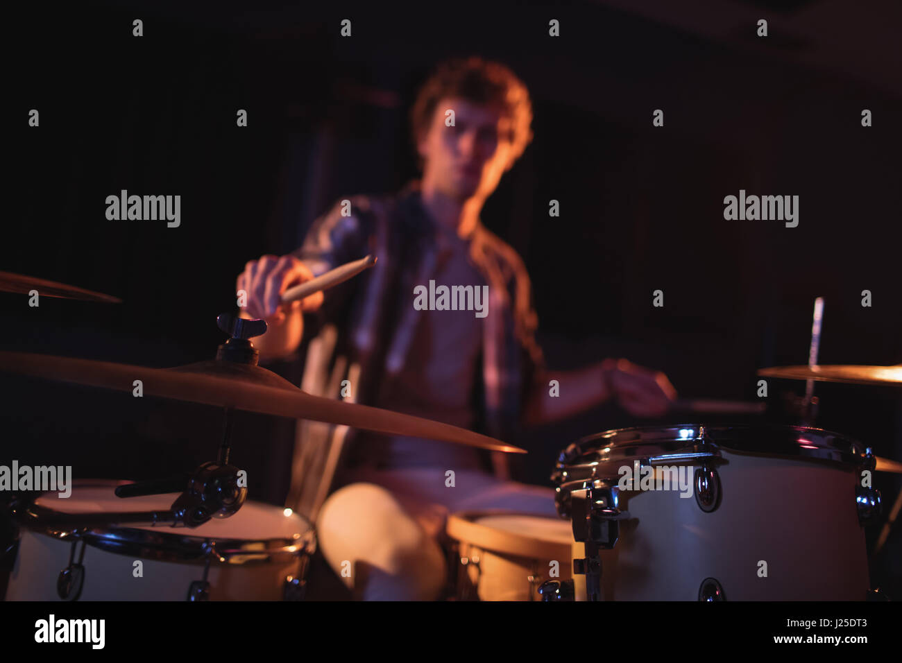 Drummer playing on drum set in recording studio Stock Photo - Alamy