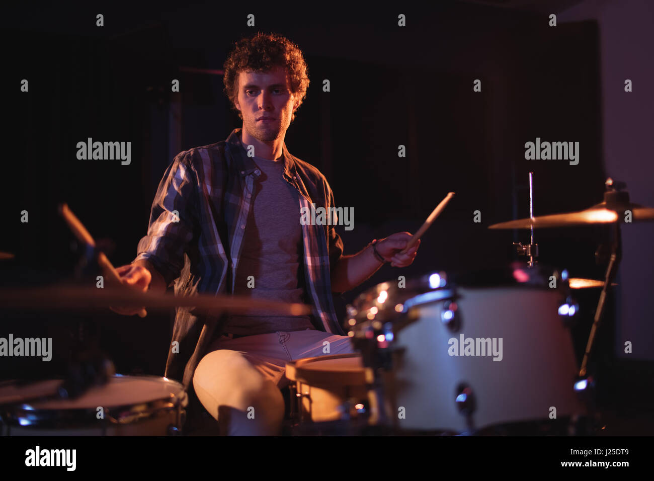 Drummer playing on drum set in recording studio Stock Photo - Alamy