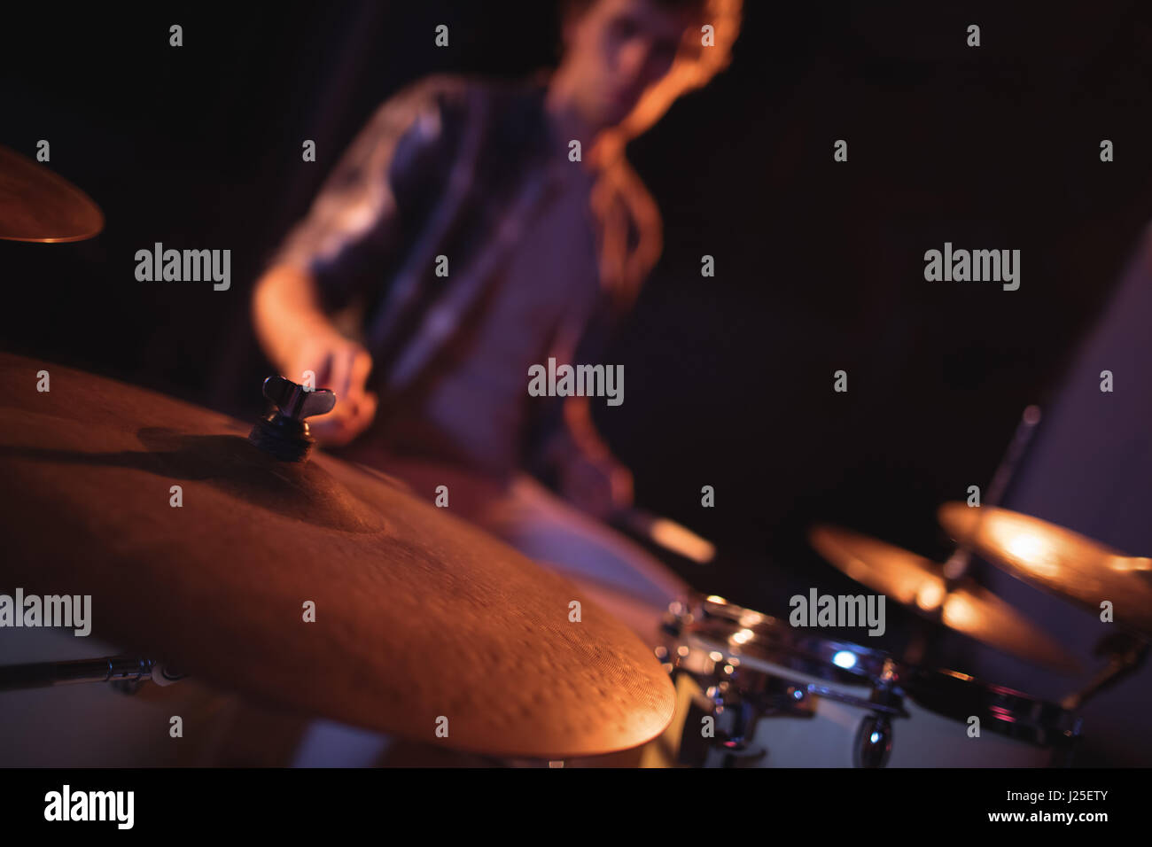 Drummer playing on drum set in recording studio Stock Photo - Alamy