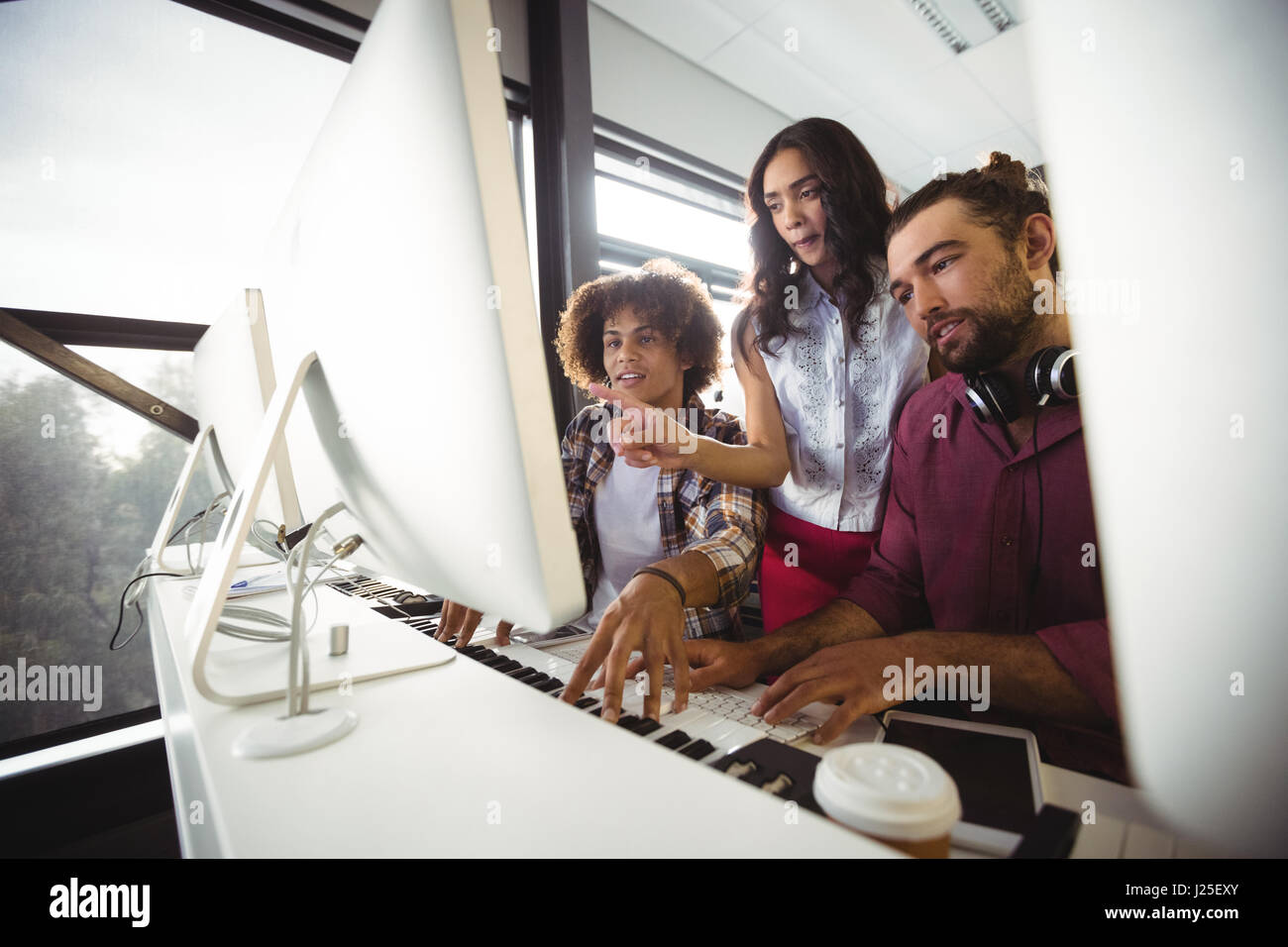 Three sound engineers working together in studio Stock Photo - Alamy