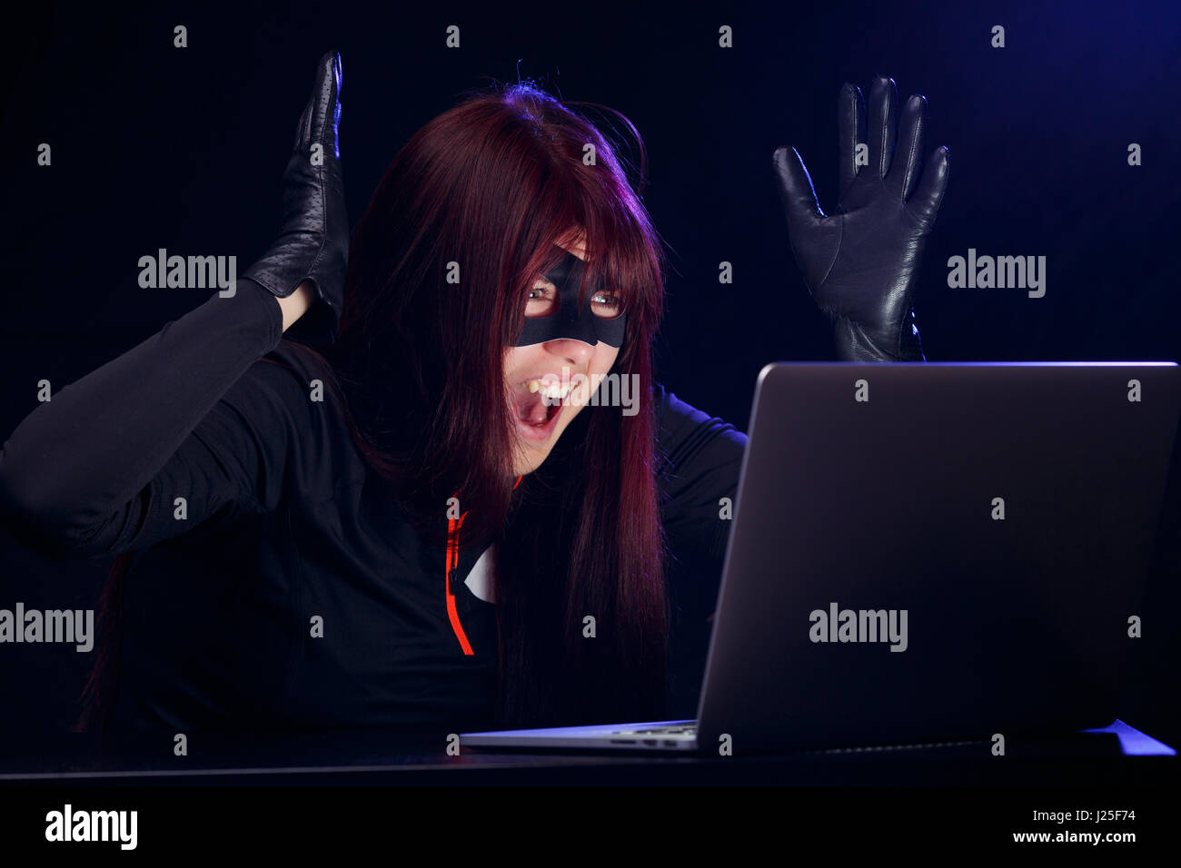 Surprised night thief in laptop Stock Photo - Alamy