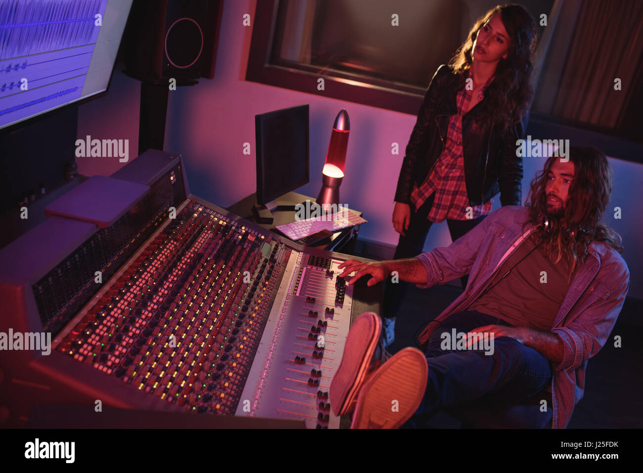 Audio engineers using sound mixer in recording studio Stock Photo Alamy